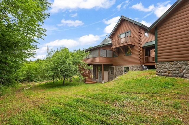 1 Peak Vista Ln, Madison, NH 03849 - rear view of house with a sunroom, stairs, log exterior, a lawn, and a balcony