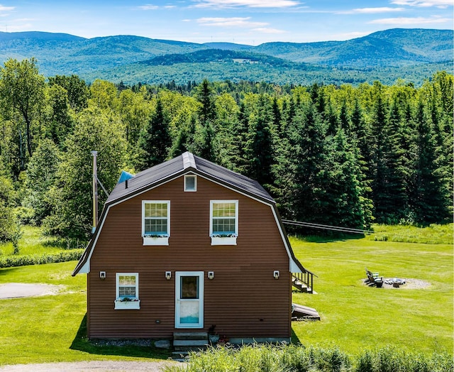 174 E Colebrook Rd, Colebrook, NH 03576 - view of front of home with entry steps, a mountain view, a gambrel roof, and a front yard