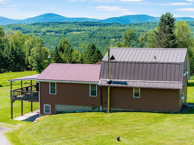 174 E Colebrook Rd, Colebrook, NH 03576 - rear view of house featuring a yard, a forest view, and a deck with mountain view