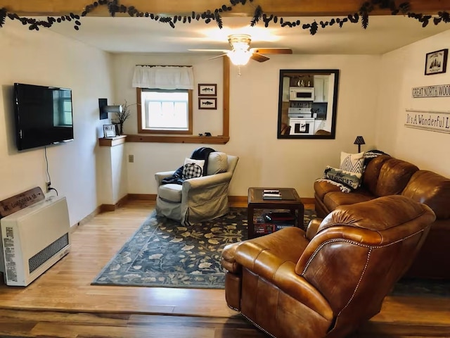 174 E Colebrook Rd, Colebrook, NH 03576 - living room with heating unit, wood finished floors, and ceiling fan
