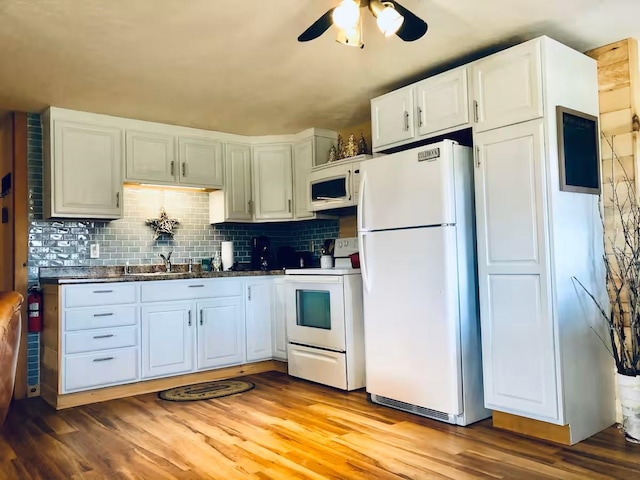 174 E Colebrook Rd, Colebrook, NH 03576 - kitchen featuring white appliances, ceiling fan, light wood-style floors, dark countertops, and tasteful backsplash