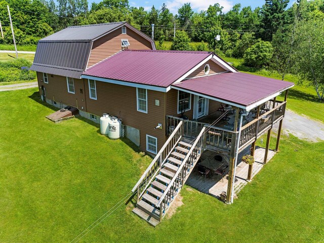 174 E Colebrook Rd, Colebrook, NH 03576 - back of property featuring a yard, stairway, a metal roof, and a gambrel roof