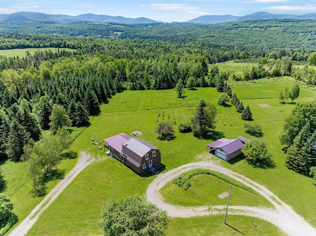 174 E Colebrook Rd, Colebrook, NH 03576 - view from above of property featuring a heavily wooded area and a mountain backdrop