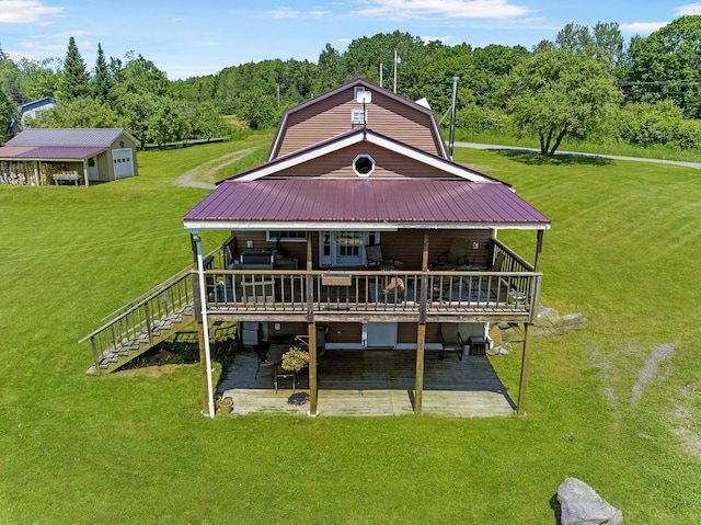 174 E Colebrook Rd, Colebrook, NH 03576 - rear view of property with a lawn, a patio area, a deck, a metal roof, and a wooded view