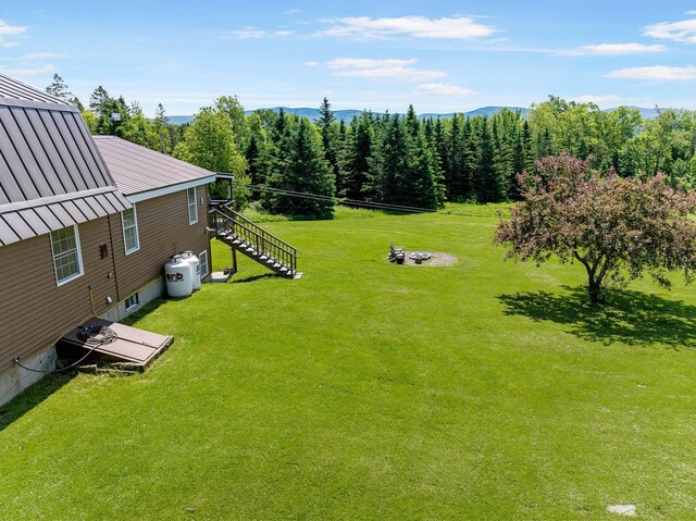 174 E Colebrook Rd, Colebrook, NH 03576 - view of grassy yard with stairs and a view of trees