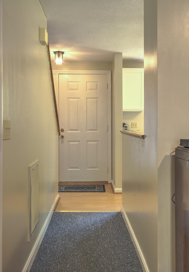 38C Stonehouse Ln, Keene, NH 03431 - doorway to outside featuring light colored carpet and a textured ceiling