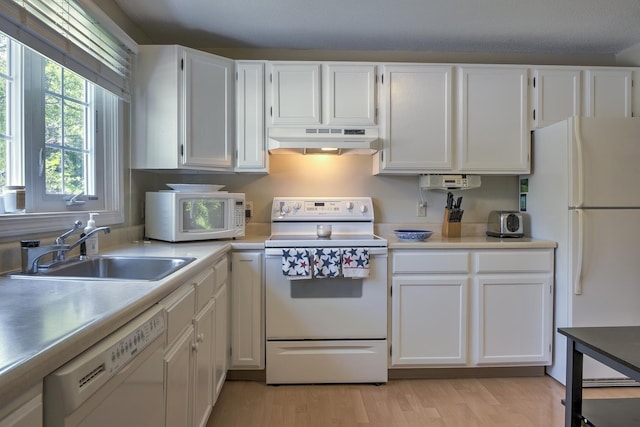 38C Stonehouse Ln, Keene, NH 03431 - kitchen with white appliances, under cabinet range hood, white cabinetry, and light wood-style flooring