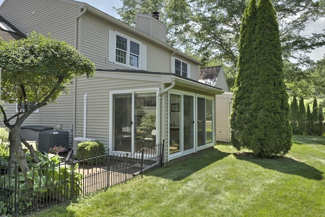 38C Stonehouse Ln, Keene, NH 03431 - rear view of house with a chimney, a sunroom, a lawn, and a patio area