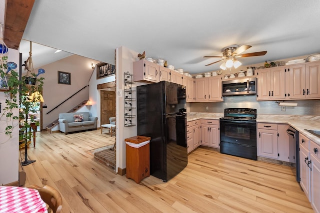 85 Lakeview Ave, Bristol, NH 03222 - kitchen featuring black appliances, light wood-style floors, ceiling fan, and decorative backsplash