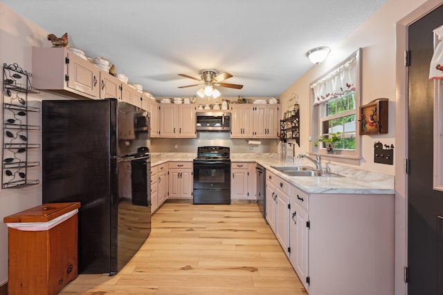 85 Lakeview Ave, Bristol, NH 03222 - kitchen featuring black appliances, ceiling fan, light wood-style flooring, and light stone countertops