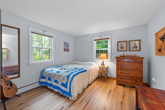 85 Lakeview Ave, Bristol, NH 03222 - bedroom with light wood-type flooring and a baseboard heating unit