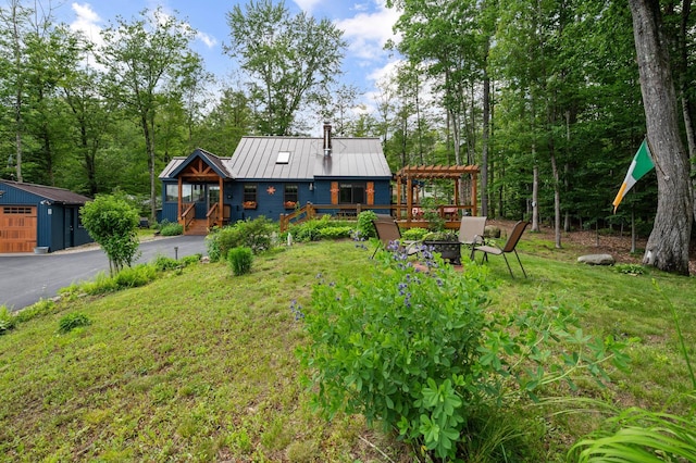 85 Lakeview Ave, Bristol, NH 03222 - rear view of property with a metal roof, a chimney, a lawn, driveway, and a standing seam roof