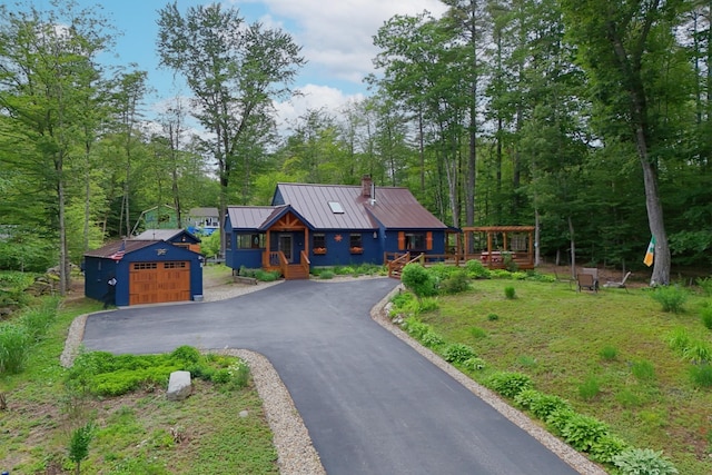 85 Lakeview Ave, Bristol, NH 03222 - view of front of property with a standing seam roof, a chimney, a metal roof, an outbuilding, and driveway