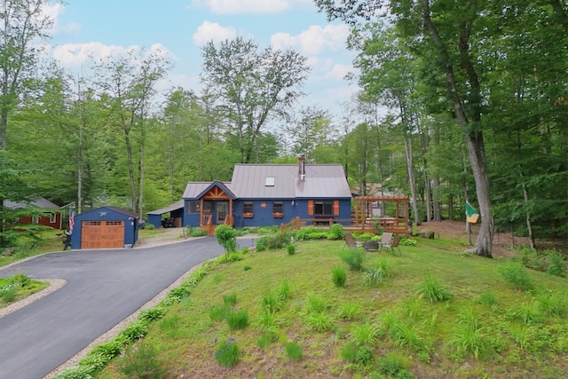 85 Lakeview Ave, Bristol, NH 03222 - view of front of home featuring an outdoor structure, a detached garage, asphalt driveway, and a metal roof