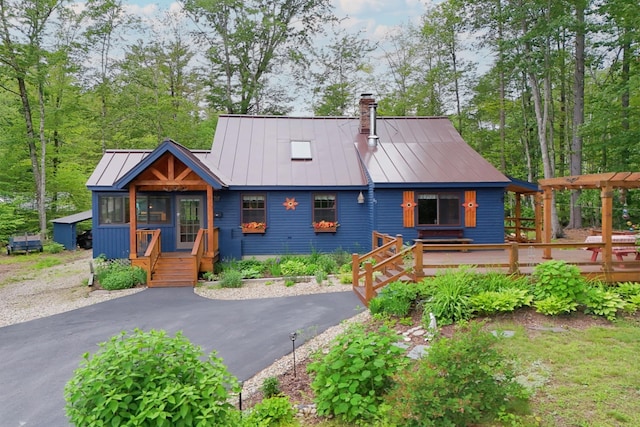 85 Lakeview Ave, Bristol, NH 03222 - chalet / cabin with a standing seam roof, a chimney, a metal roof, and a deck