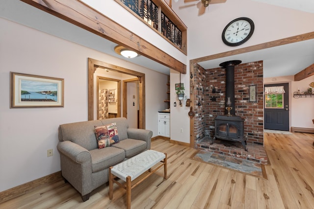 85 Lakeview Ave, Bristol, NH 03222 - living room featuring a wood stove, wood finished floors, and a ceiling fan