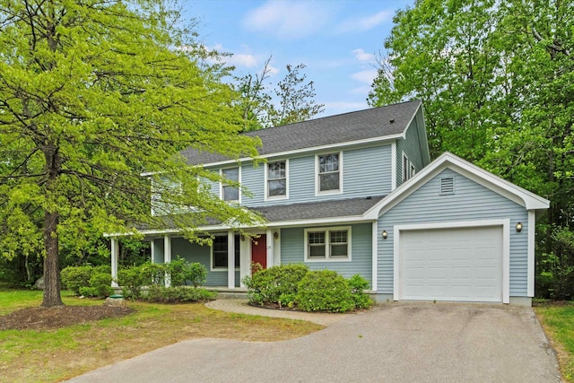 25 Sweetbrier Way, Laconia, NH 03246 - view of front facade with driveway, an attached garage, covered porch, and a shingled roof