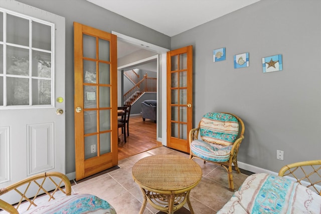 25 Sweetbrier Way, Laconia, NH 03246 - sitting room featuring light tile patterned flooring, french doors, and stairway