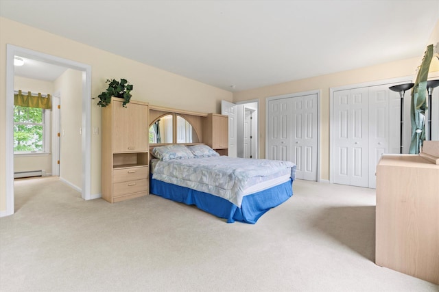 25 Sweetbrier Way, Laconia, NH 03246 - bedroom featuring a baseboard radiator, light colored carpet, and two closets