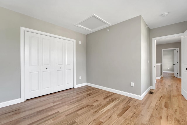 36 Laperle Dr, Rochester, NH 03867 - unfurnished bedroom with attic access, light wood finished floors, and a closet