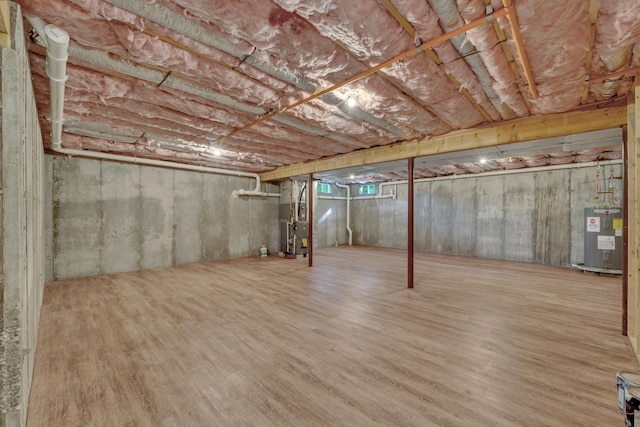36 Laperle Dr, Rochester, NH 03867 - unfinished basement featuring water heater, heating unit, and wood finished floors
