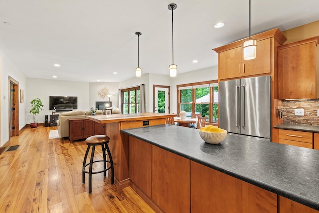 10 Benjamins Way, Hollis, NH 03049 - kitchen featuring high quality fridge, light wood finished floors, tasteful backsplash, recessed lighting, and dark countertops