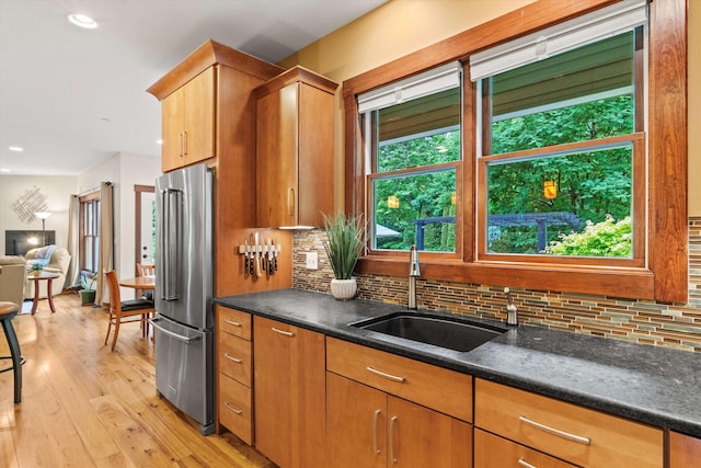 10 Benjamins Way, Hollis, NH 03049 - kitchen with freestanding refrigerator, light wood finished floors, backsplash, recessed lighting, and brown cabinets