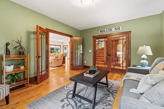 10 Benjamins Way, Hollis, NH 03049 - living area featuring french doors and wood finished floors