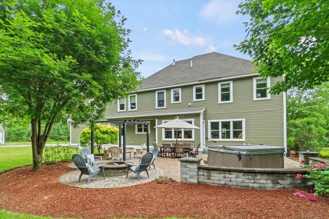10 Benjamins Way, Hollis, NH 03049 - back of house featuring a hot tub, a patio, a fire pit, and a shingled roof