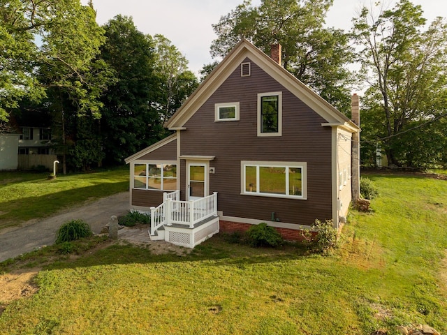 24 Church St, Wakefield, NH 03872 - view of front of property with a chimney and a front yard