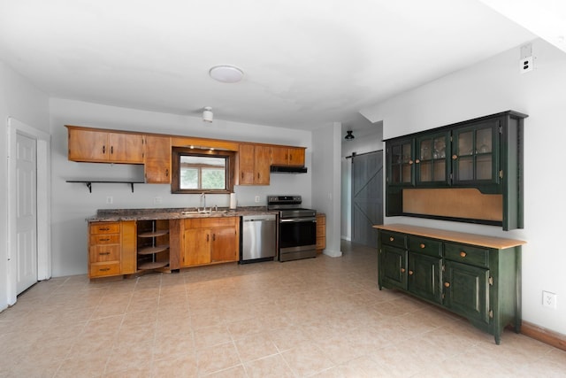 24 Church St, Wakefield, NH 03872 - kitchen featuring appliances with stainless steel finishes, a barn door, open shelves, and glass insert cabinets