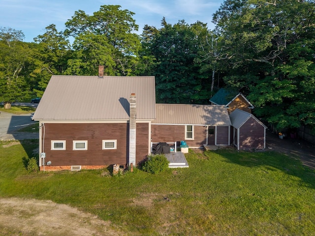 24 Church St, Wakefield, NH 03872 - rear view of house featuring a chimney, a yard, and a metal roof