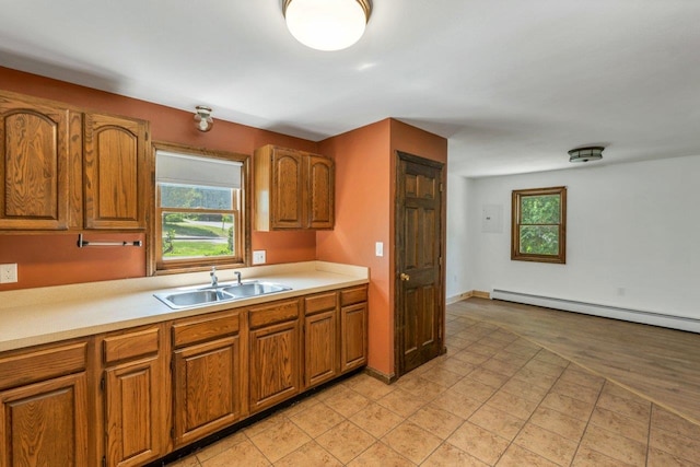 66 Millville St, Salem, NH 03079 - kitchen featuring brown cabinets, light countertops, plenty of natural light, and baseboard heating