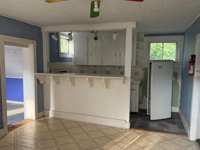 60 S St S, Proctor, VT 05763 - kitchen with a breakfast bar area, light flooring, and light countertops
