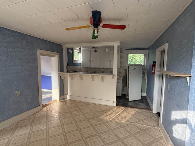 60 S St S, Proctor, VT 05763 - kitchen featuring plenty of natural light, a ceiling fan, a kitchen breakfast bar, and tile patterned floors