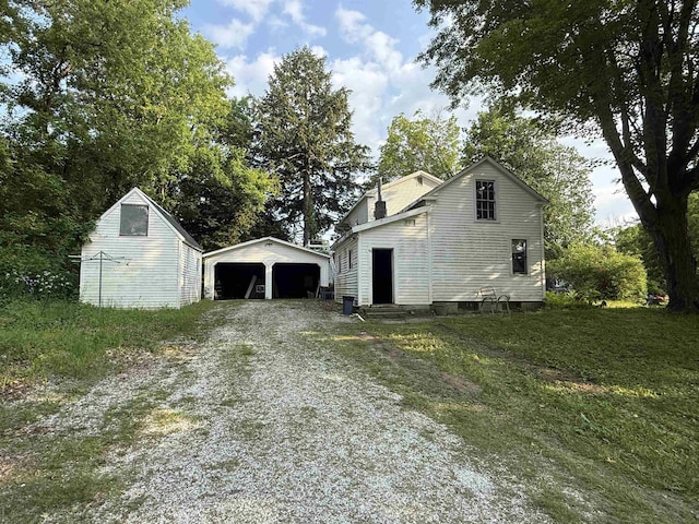 60 S St S, Proctor, VT 05763 - view of side of home with an outbuilding, entry steps, driveway, and a garage