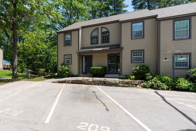 1465 Hooksett Rd Unit 209, Hooksett, NH 03106 - view of front of property with uncovered parking and a shingled roof