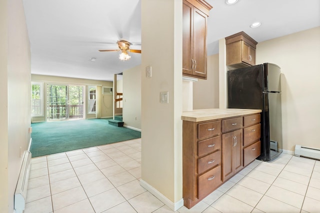 1465 Hooksett Rd Unit 209, Hooksett, NH 03106 - kitchen with baseboard heating, light colored carpet, freestanding refrigerator, a ceiling fan, and light countertops