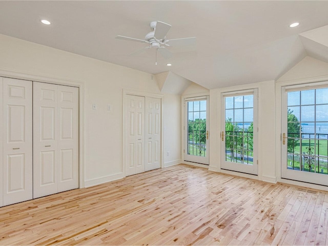 200 Lake St Unit 10, Burlington, VT 05401 - unfurnished bedroom featuring access to outside, wood finished floors, multiple windows, two closets, and lofted ceiling