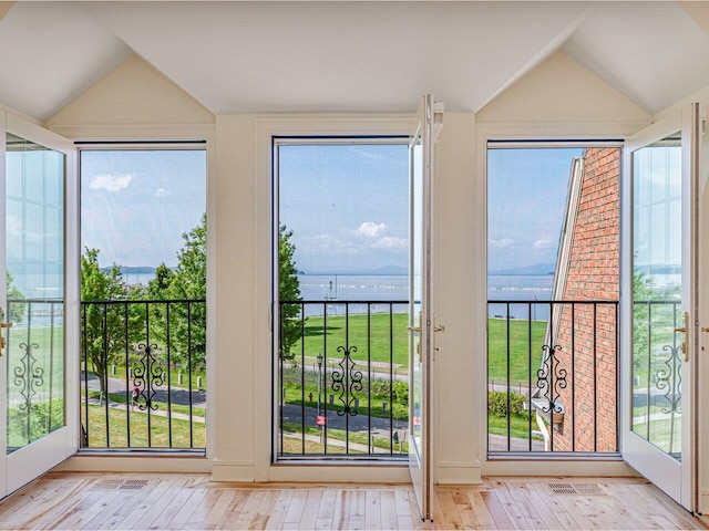 200 Lake St Unit 10, Burlington, VT 05401 - entryway with vaulted ceiling, a water view, hardwood / wood-style flooring, and healthy amount of natural light