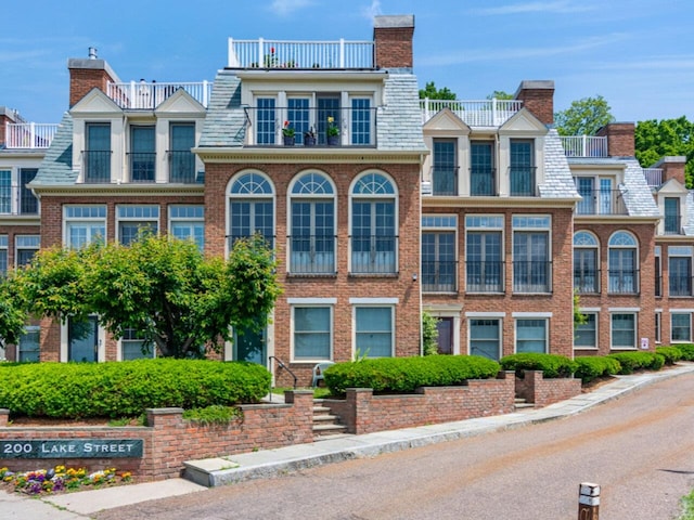 200 Lake St Unit 10, Burlington, VT 05401 - view of front facade with brick siding, mansard roof, a high end roof, and a chimney