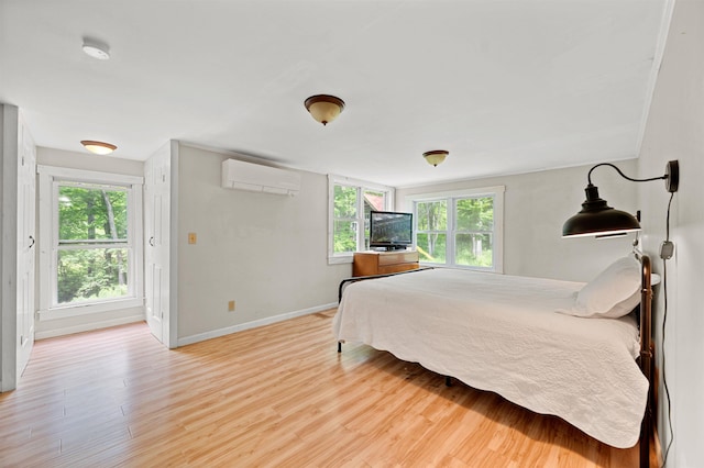 91 Robert Ln, Plainfield, VT 05667 - bedroom featuring a wall mounted AC, wood finished floors, and multiple windows