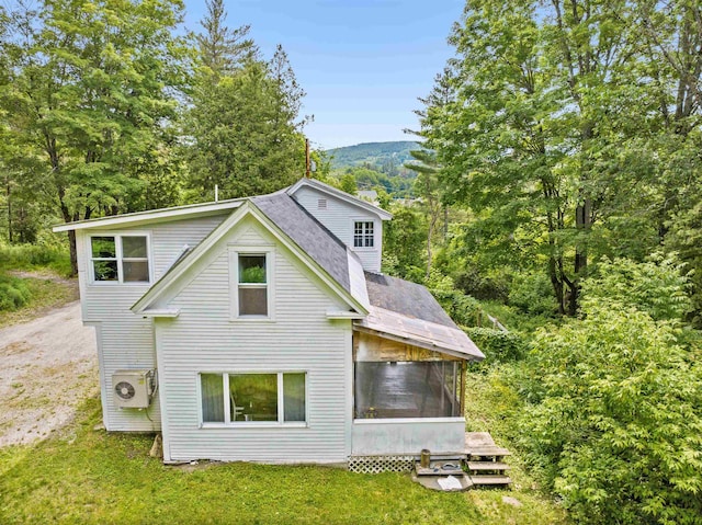 91 Robert Ln, Plainfield, VT 05667 - rear view of house with a sunroom, a shingled roof, a yard, and driveway
