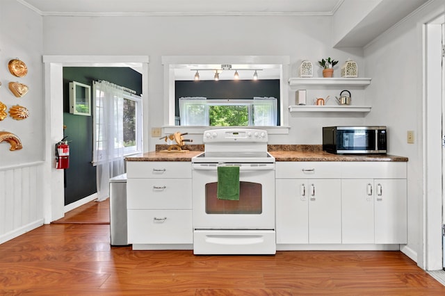 91 Robert Ln, Plainfield, VT 05667 - kitchen with electric range, stainless steel microwave, white cabinetry, wood finished floors, and ornamental molding
