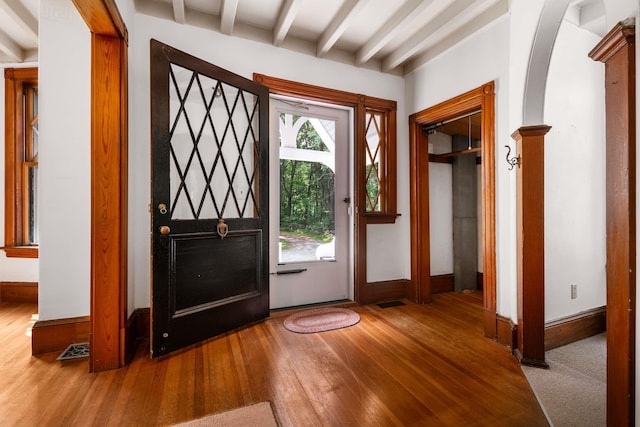 4 Fairbourne Ln, York, ME 03902 - foyer featuring hardwood / wood-style floors, beamed ceiling, and arched walkways