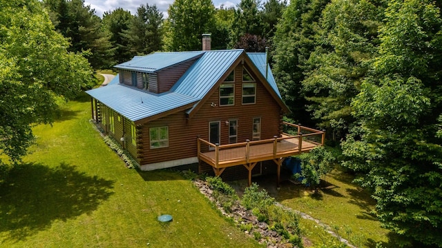 7 Reidy Way, Littleton, NH 03561 - rear view of property featuring log siding, a deck, a lawn, and a metal roof