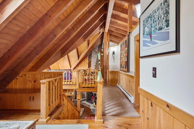 7 Reidy Way, Littleton, NH 03561 - interior space featuring a baseboard radiator, wood walls, wooden ceiling, wood finished floors, and a wainscoted wall