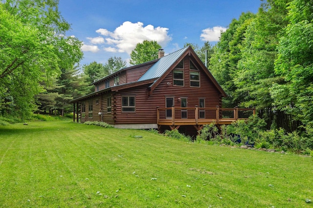 7 Reidy Way, Littleton, NH 03561 - back of property with a yard, log exterior, a chimney, a metal roof, and a wooden deck
