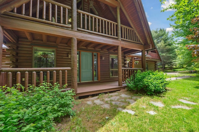 7 Reidy Way, Littleton, NH 03561 - doorway to property with log siding, a balcony, and a lawn