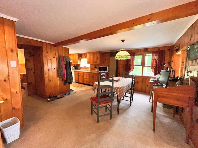 124 Spooner Rd, Pittsburg, NH 03592 - dining room featuring wood walls, light colored carpet, beamed ceiling, and ornamental molding